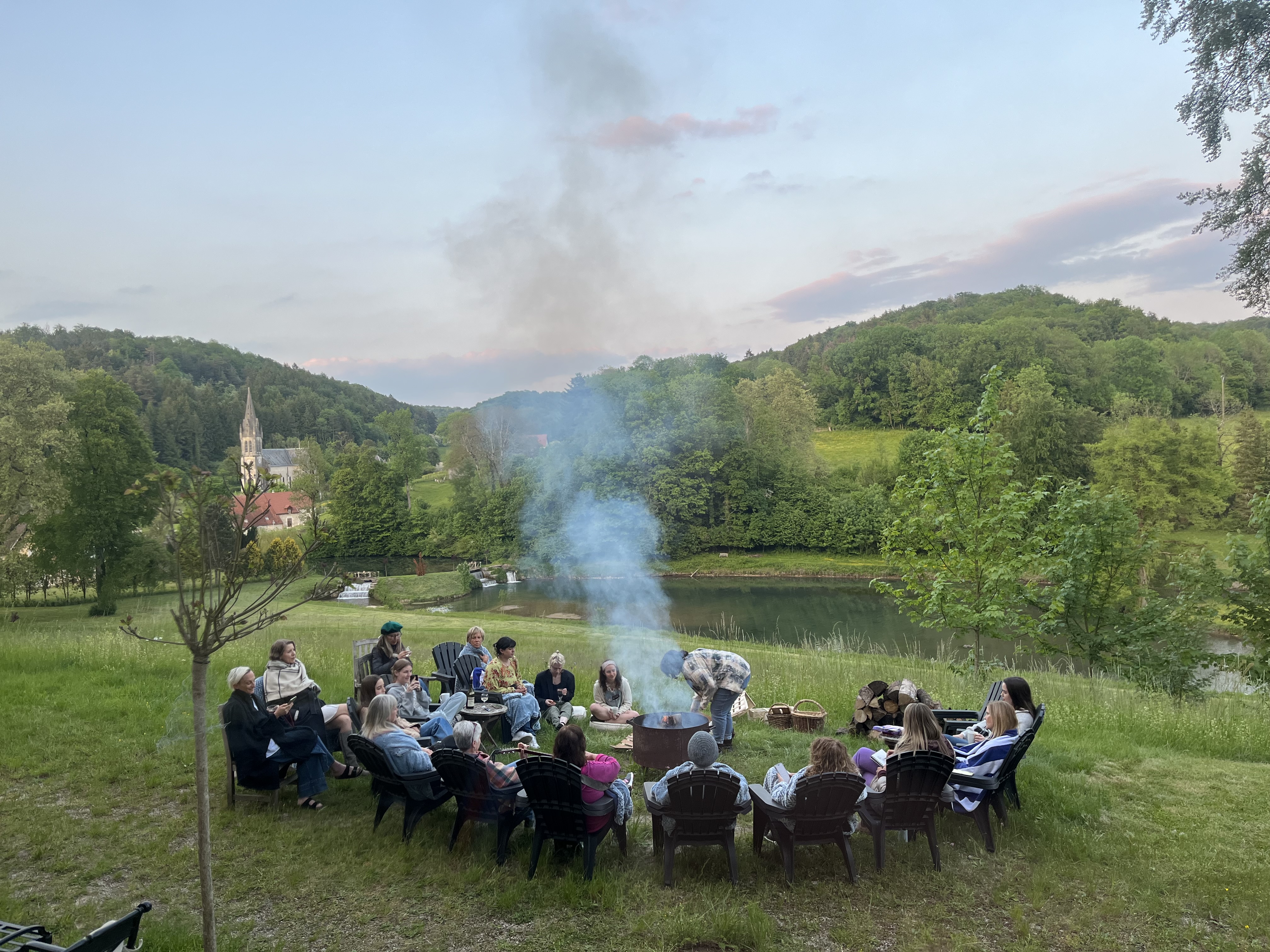 Art residency gathering around a fire